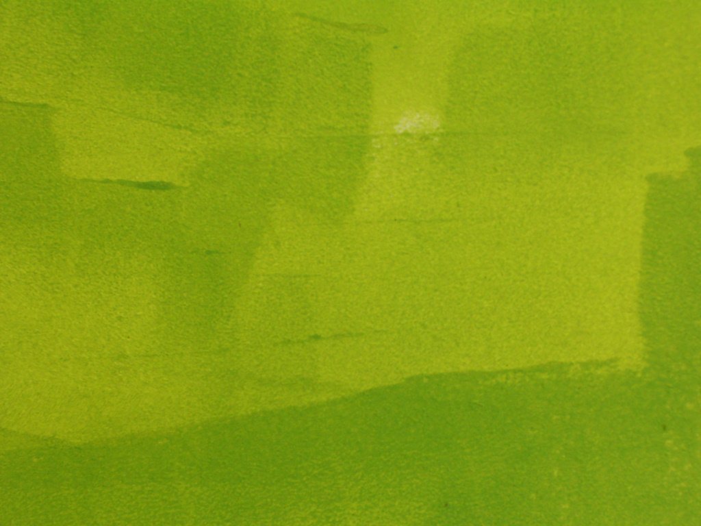 bright green abstract background with small shadows and stains