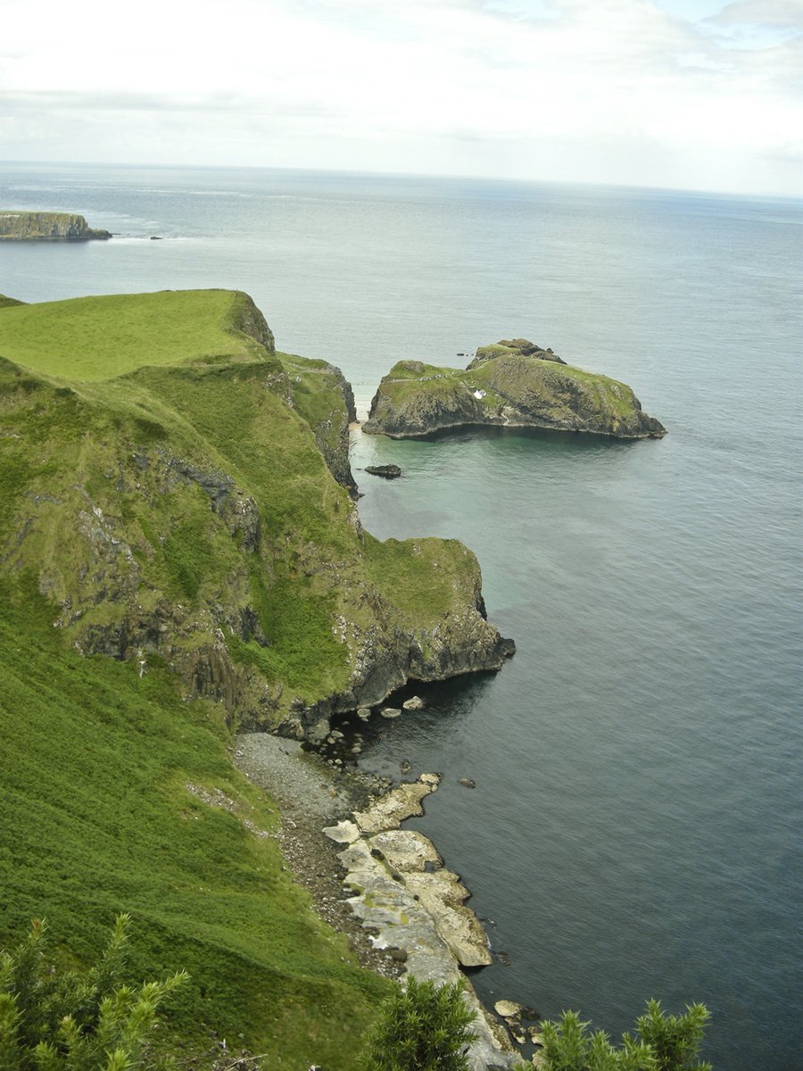 two islands on green hills on the ocean