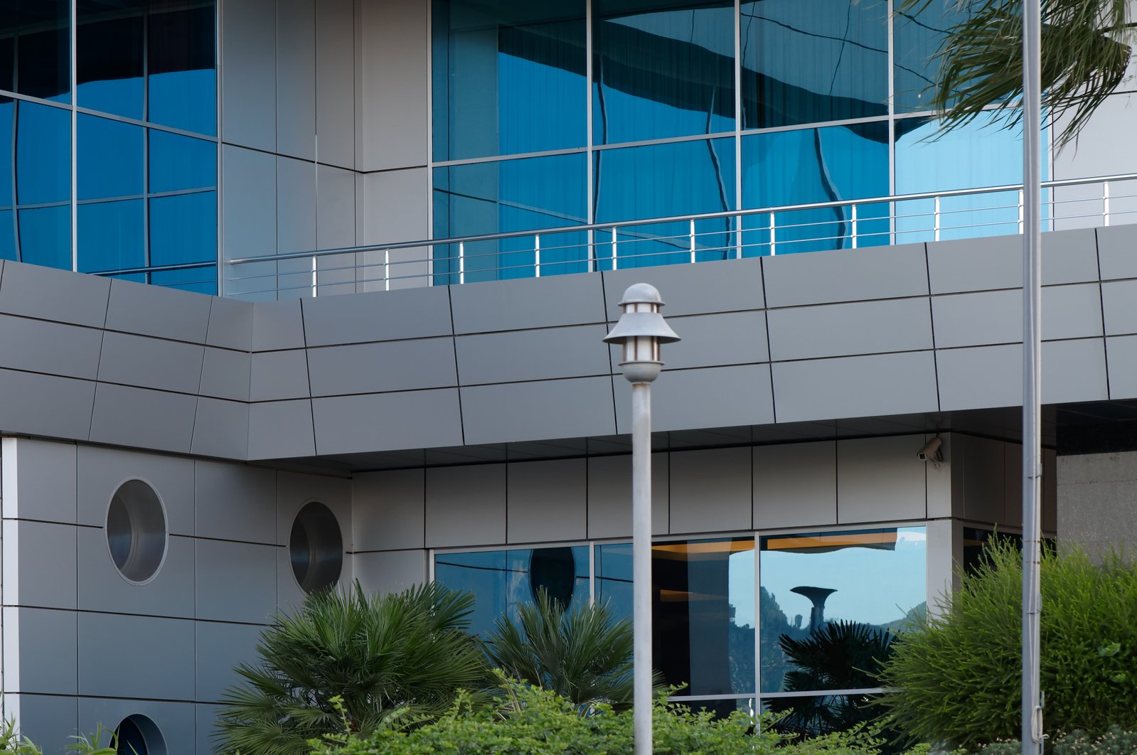 a white clock mounted to the side of a building