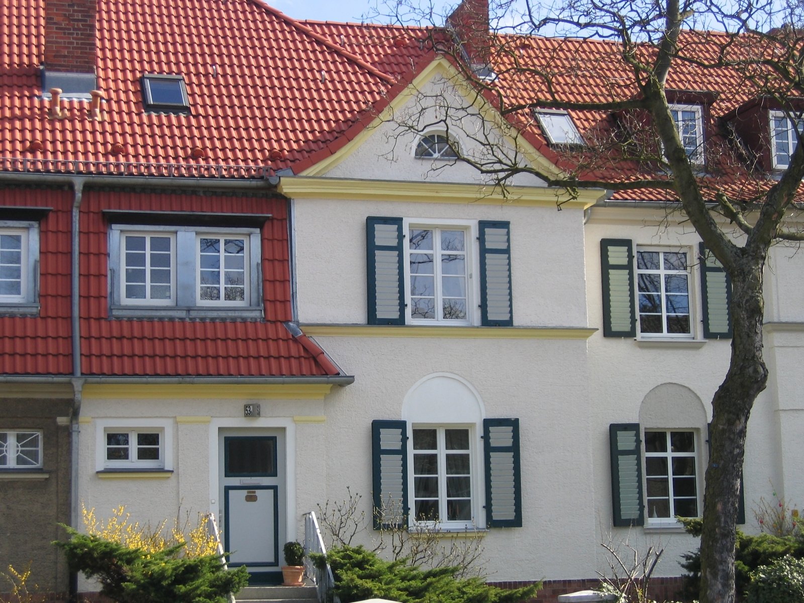 this old house is one of the few remaining houses with beautiful red and white tiled roofs