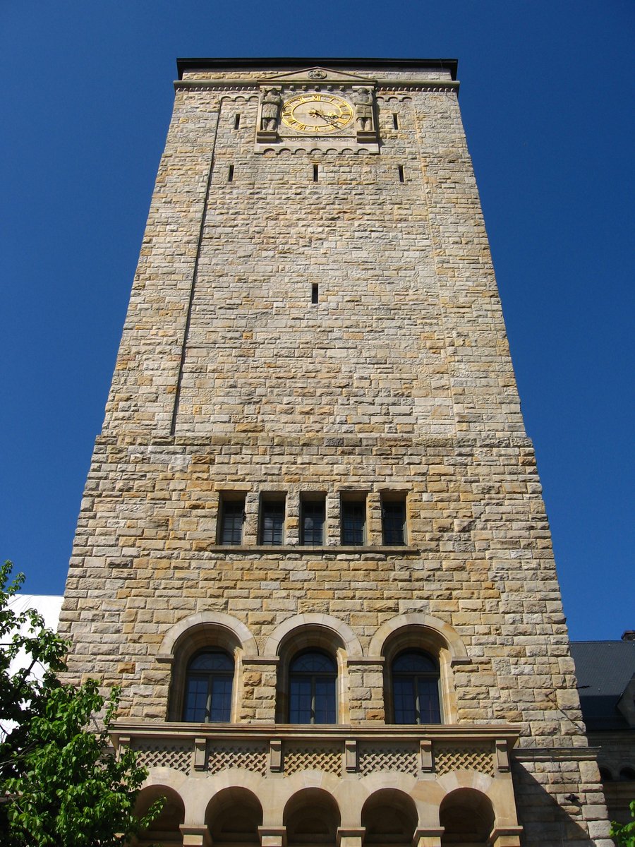 tall brick clock tower in the city center of town
