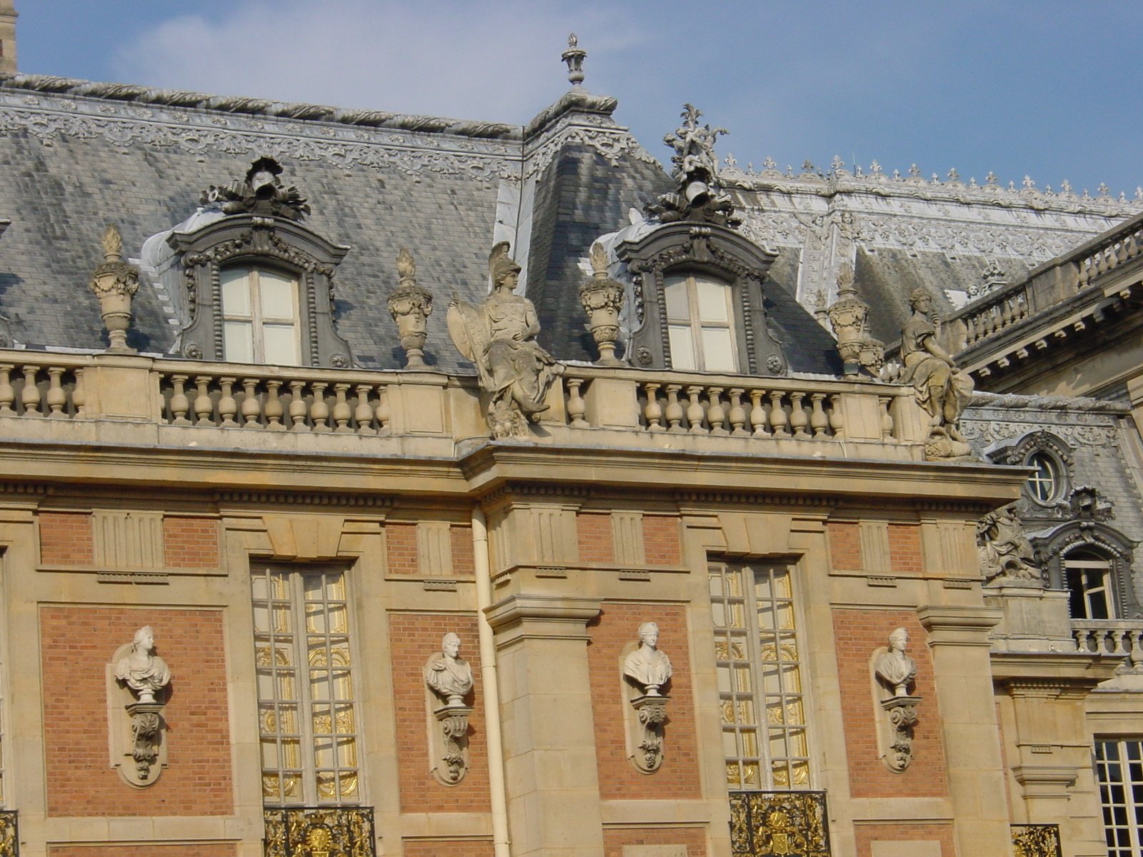 two large buildings with statues on their windows
