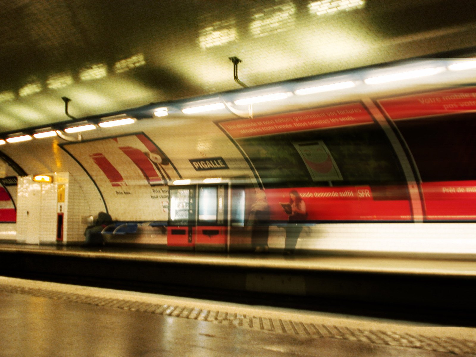 blurred image of train going by on the tracks at night