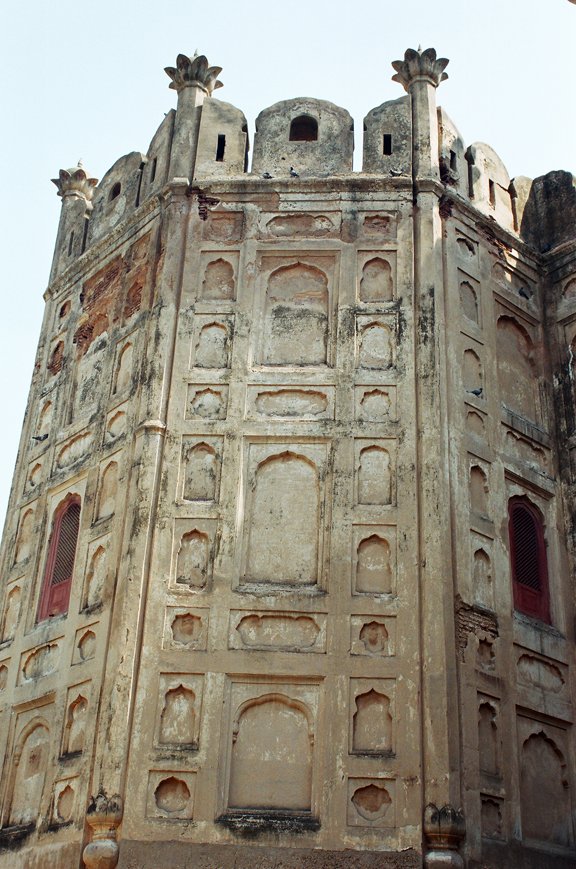 a tower with three red doors is up on the side