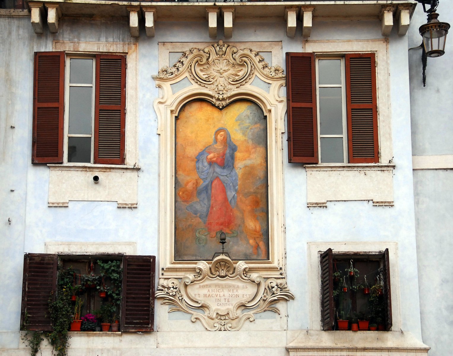 a painting above the window is on a building