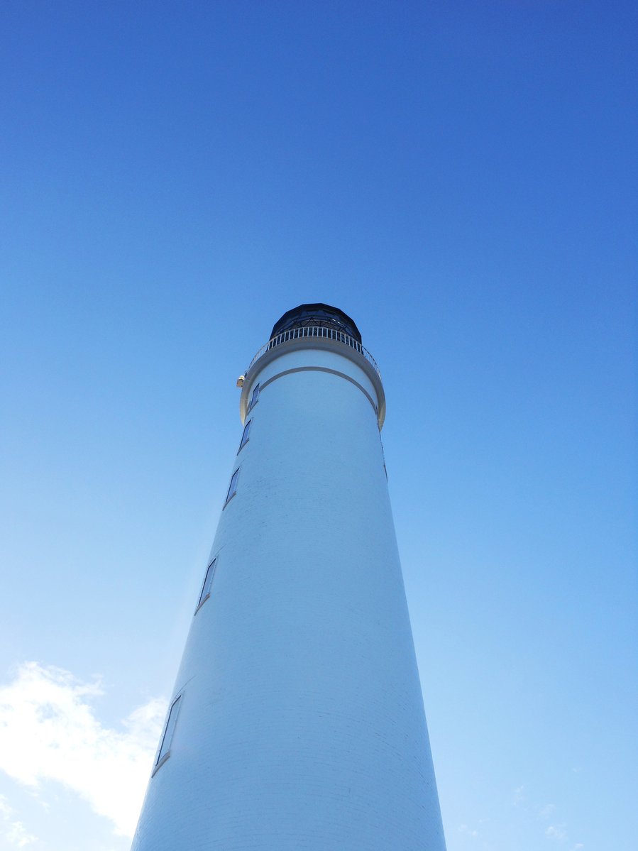 a large light house on a sunny day