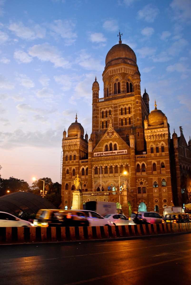 an ornate building lit up at night in the city