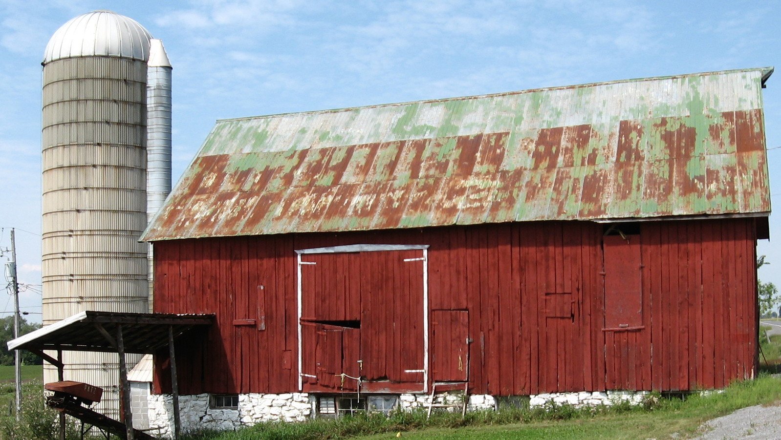the red barn has an old paint peeling off