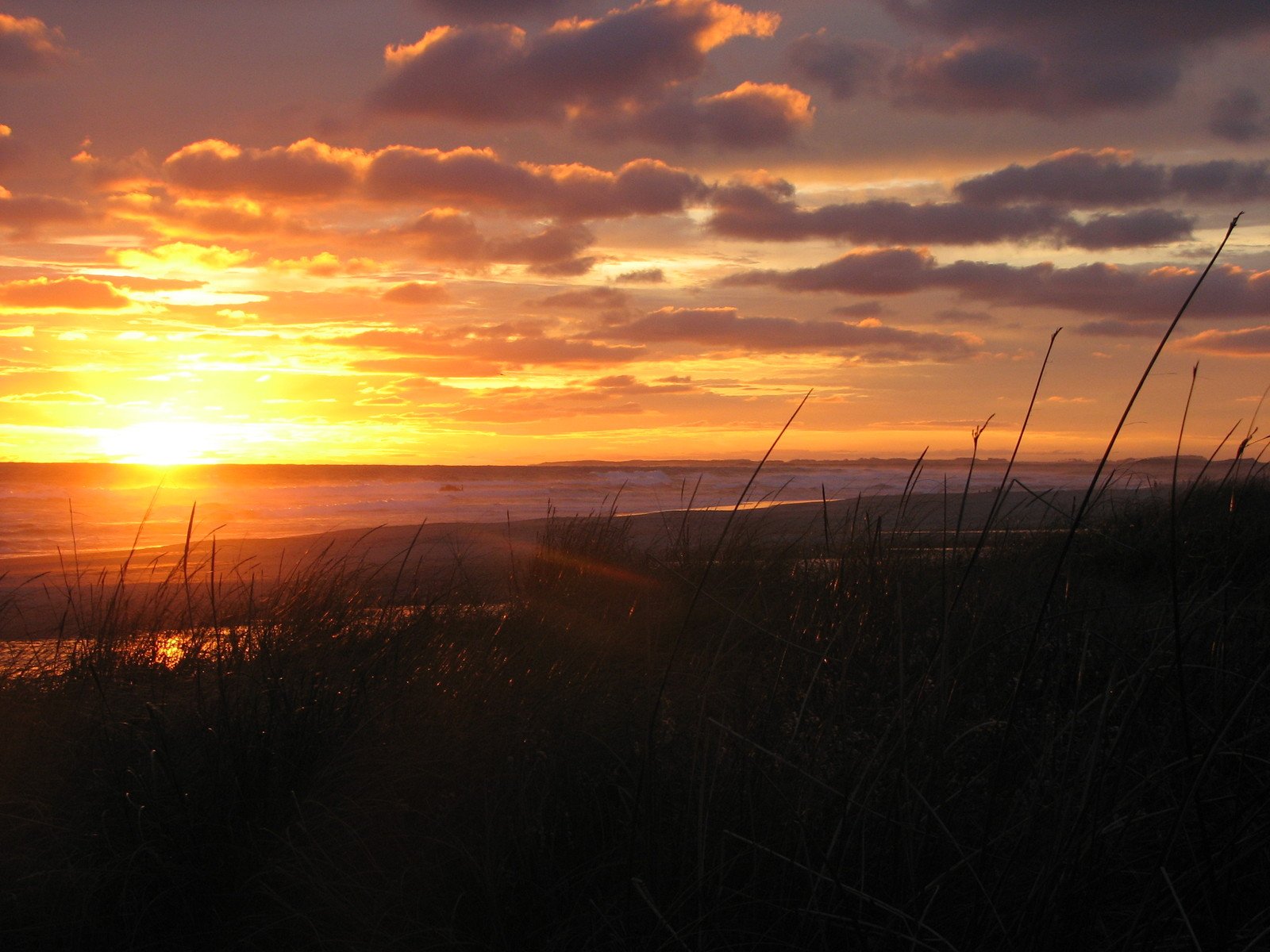 the sun setting over a body of water