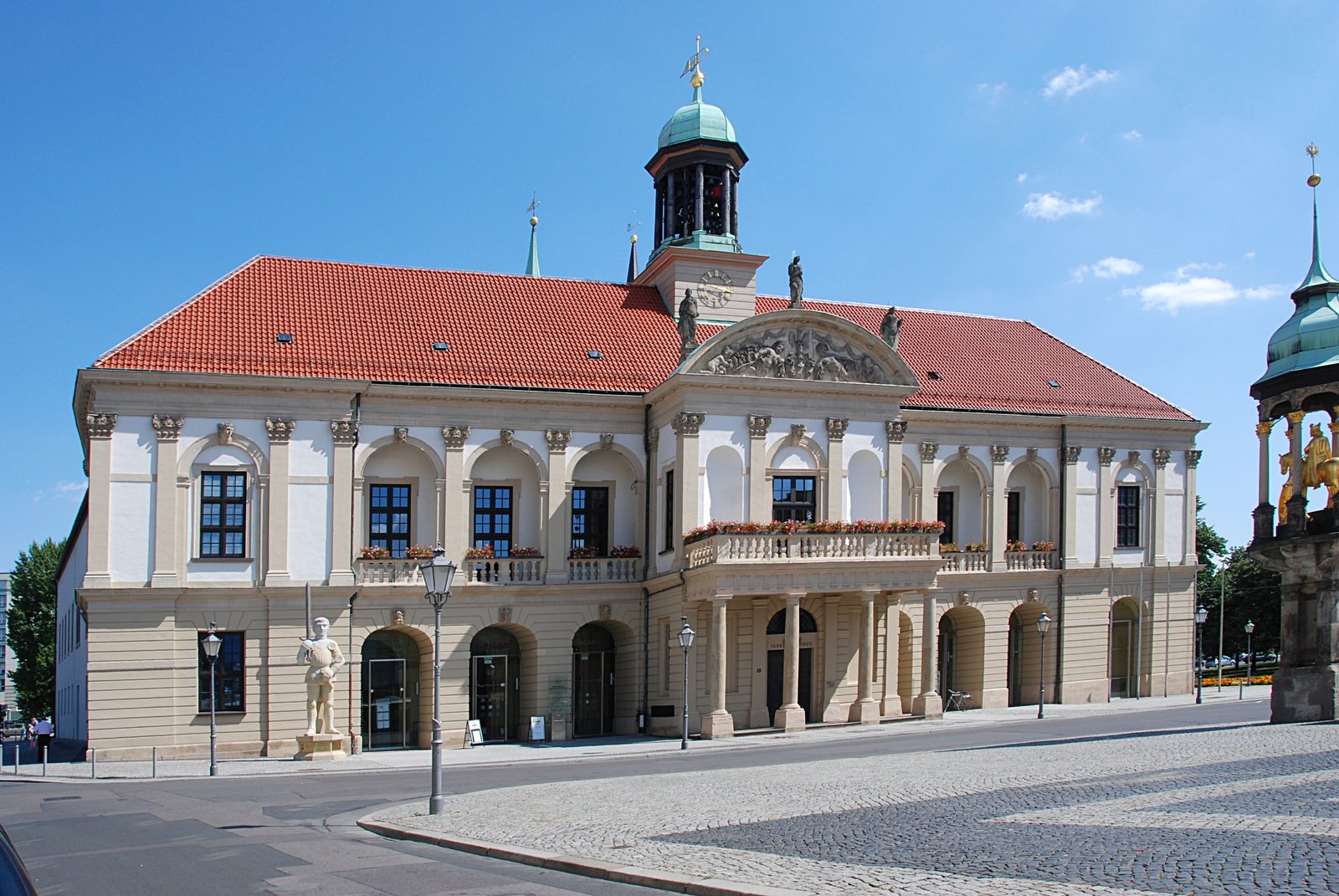 there is an older building that has a small clock on the roof