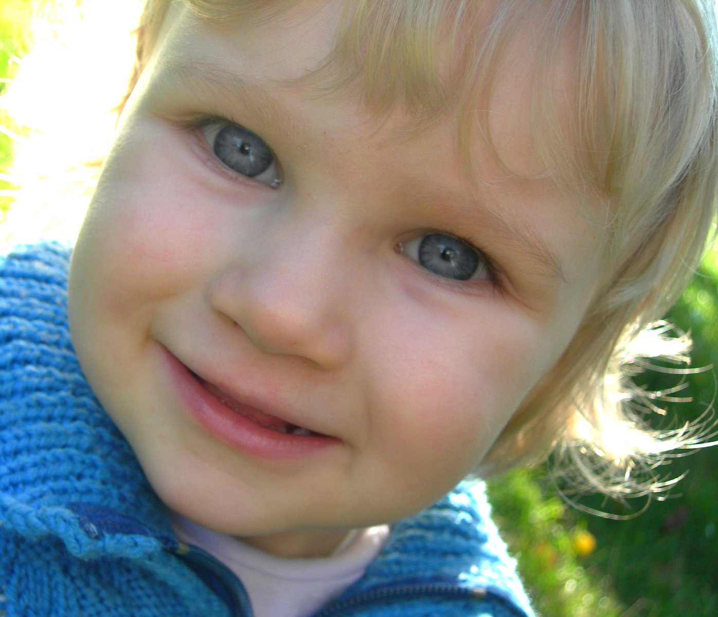 a close up of a little child with blue eyes