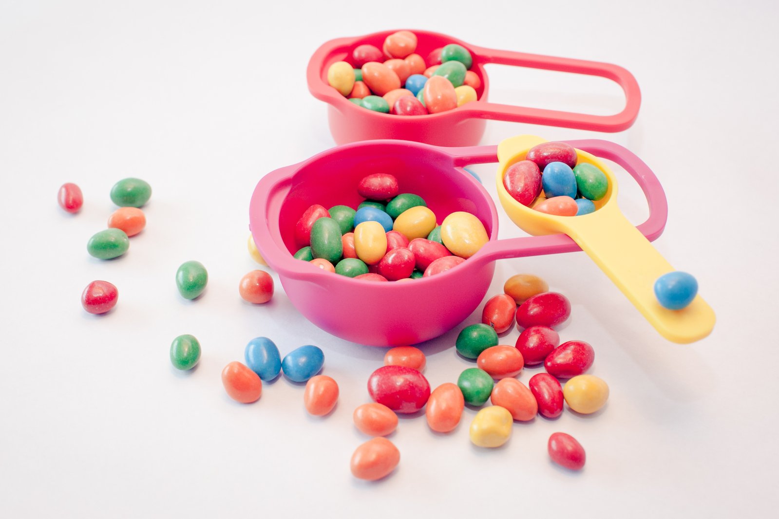 colorful candy candy and measuring spoons on the table