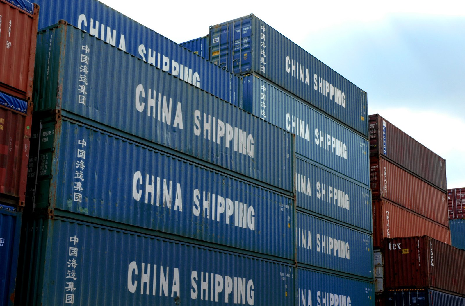 stack of cargo containers with china shipping written on them