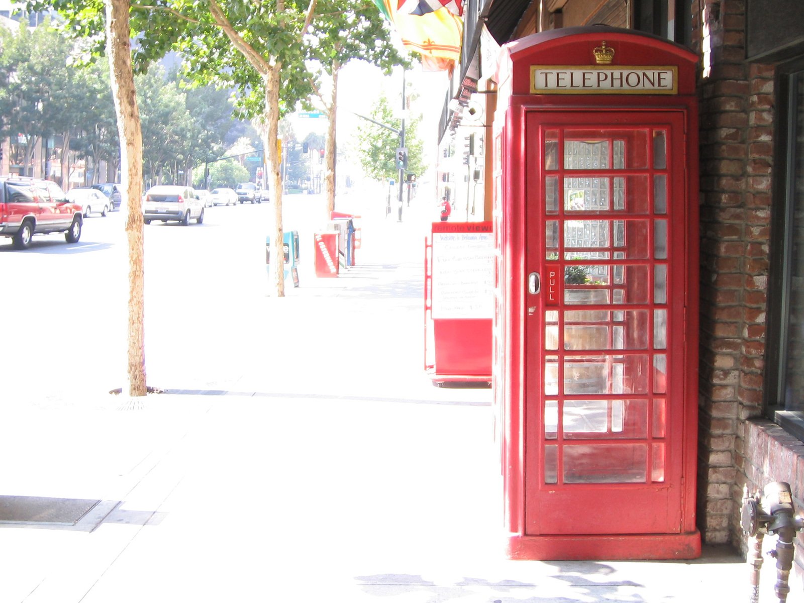a red telephone booth next to a building