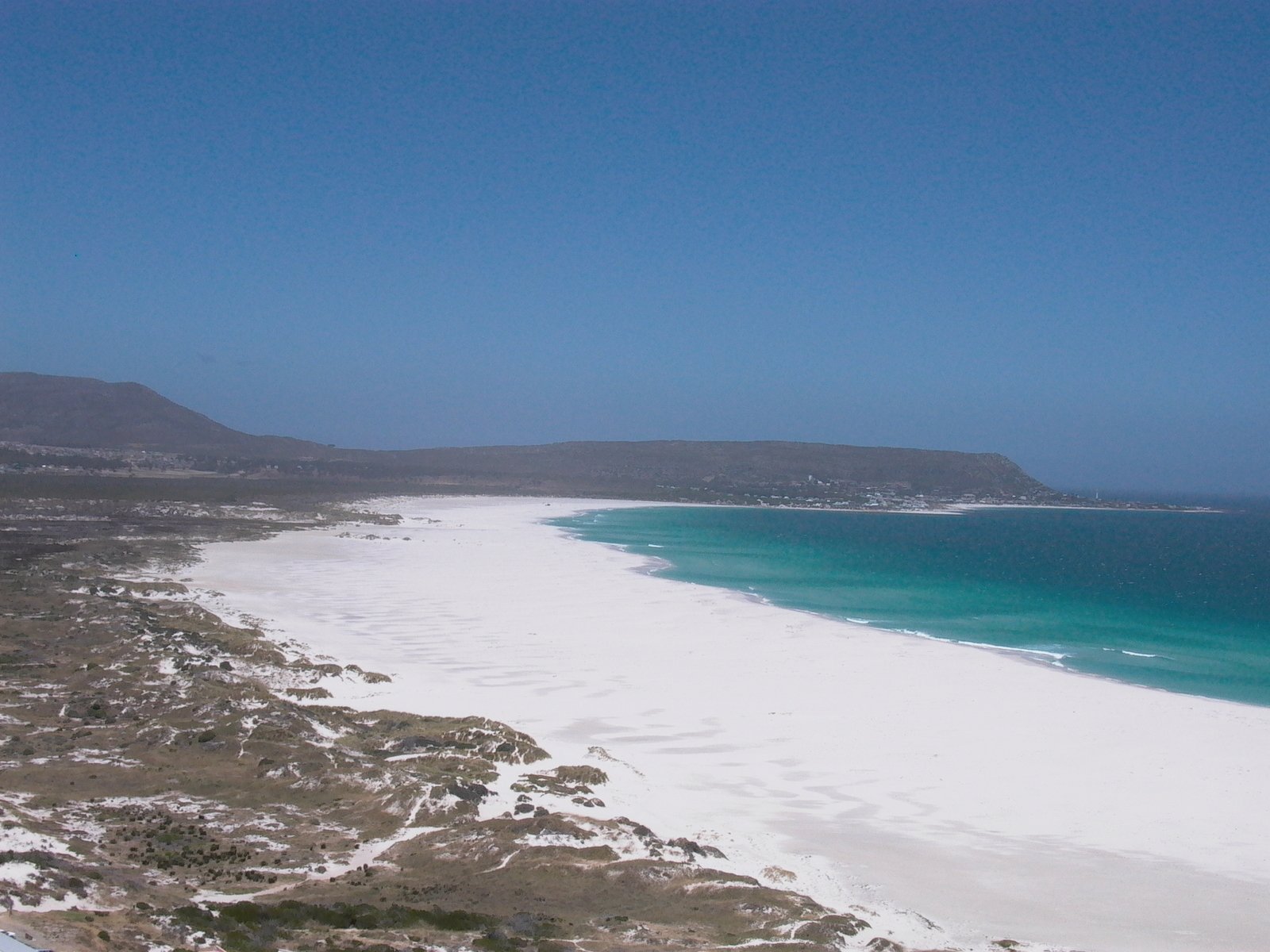 blue sky above sandy beach on the coast