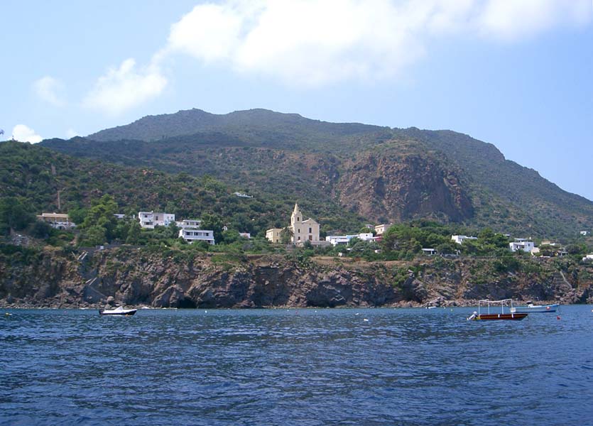 several small boats in the middle of the ocean