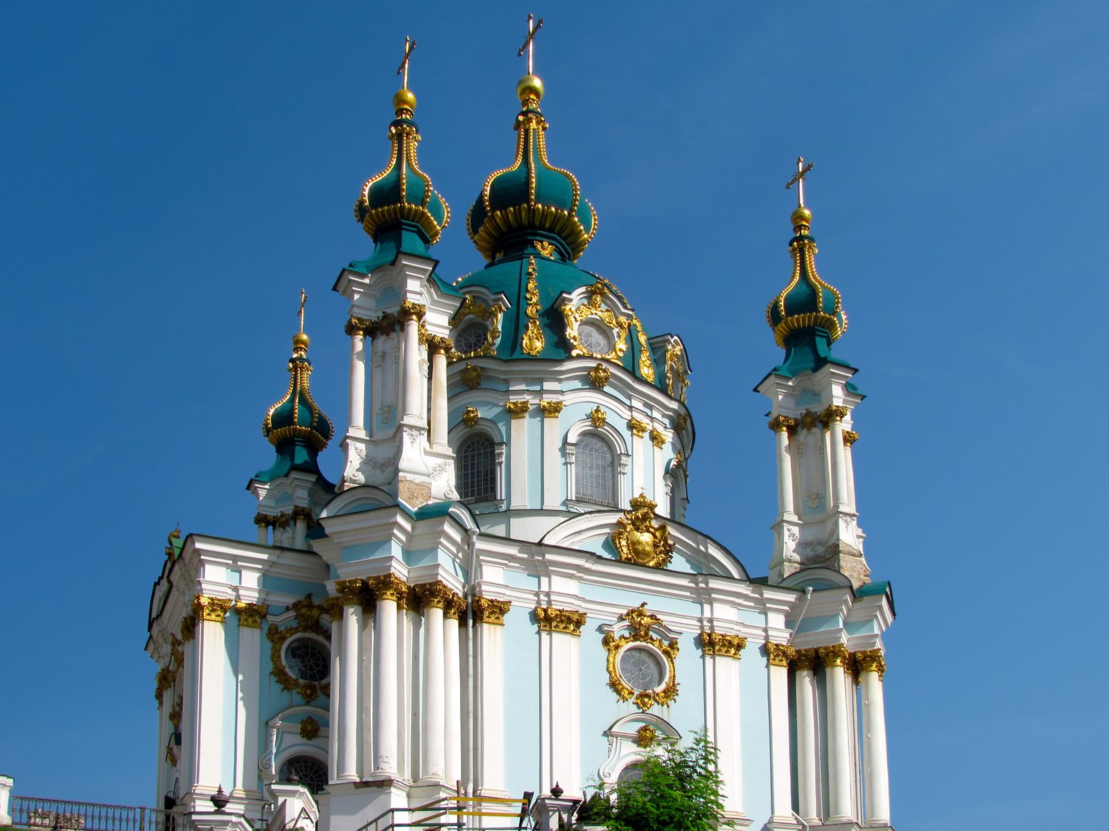 a large white church building with gold and blue steeples