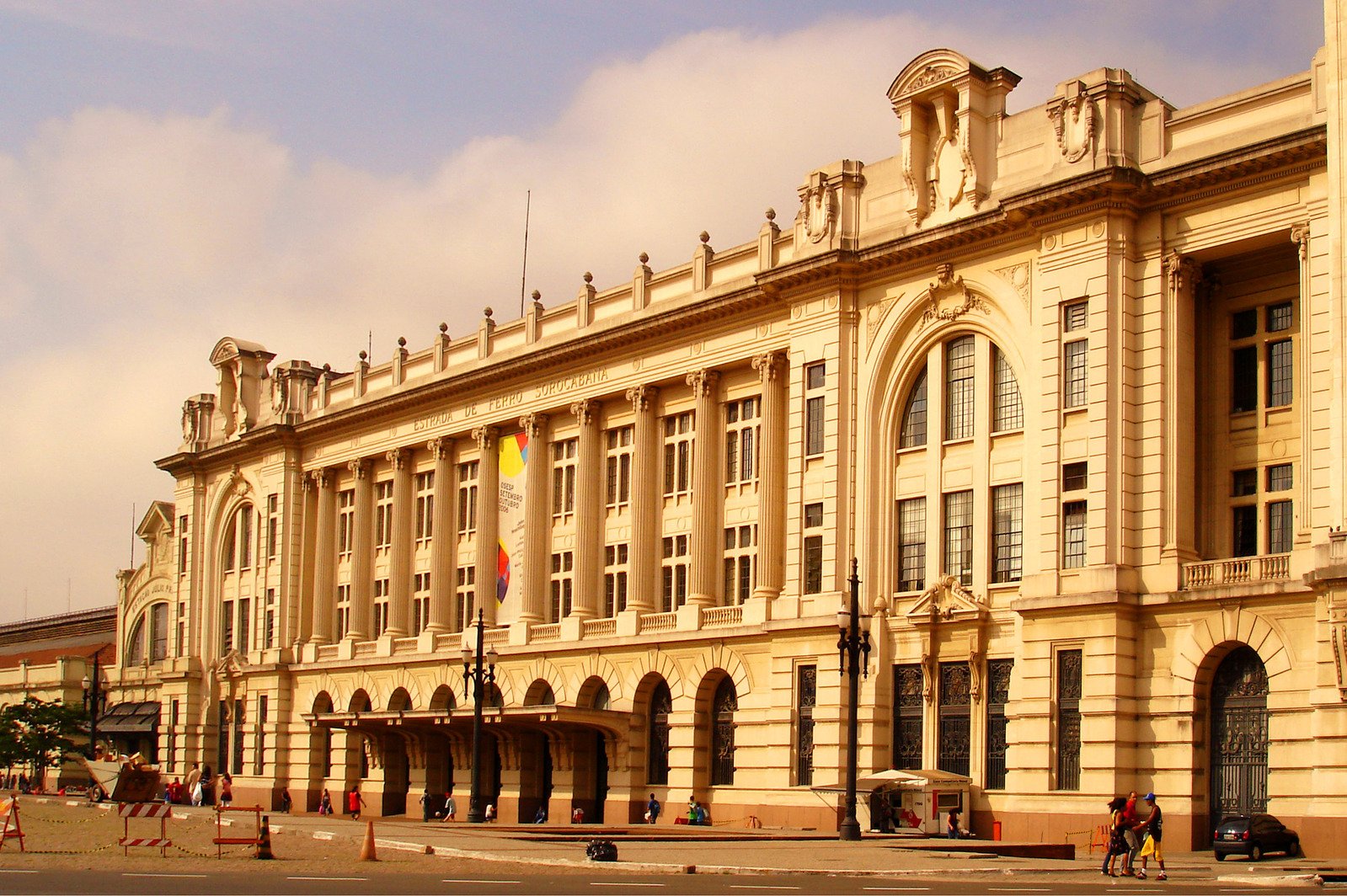 two horses are crossing the street in front of an old building