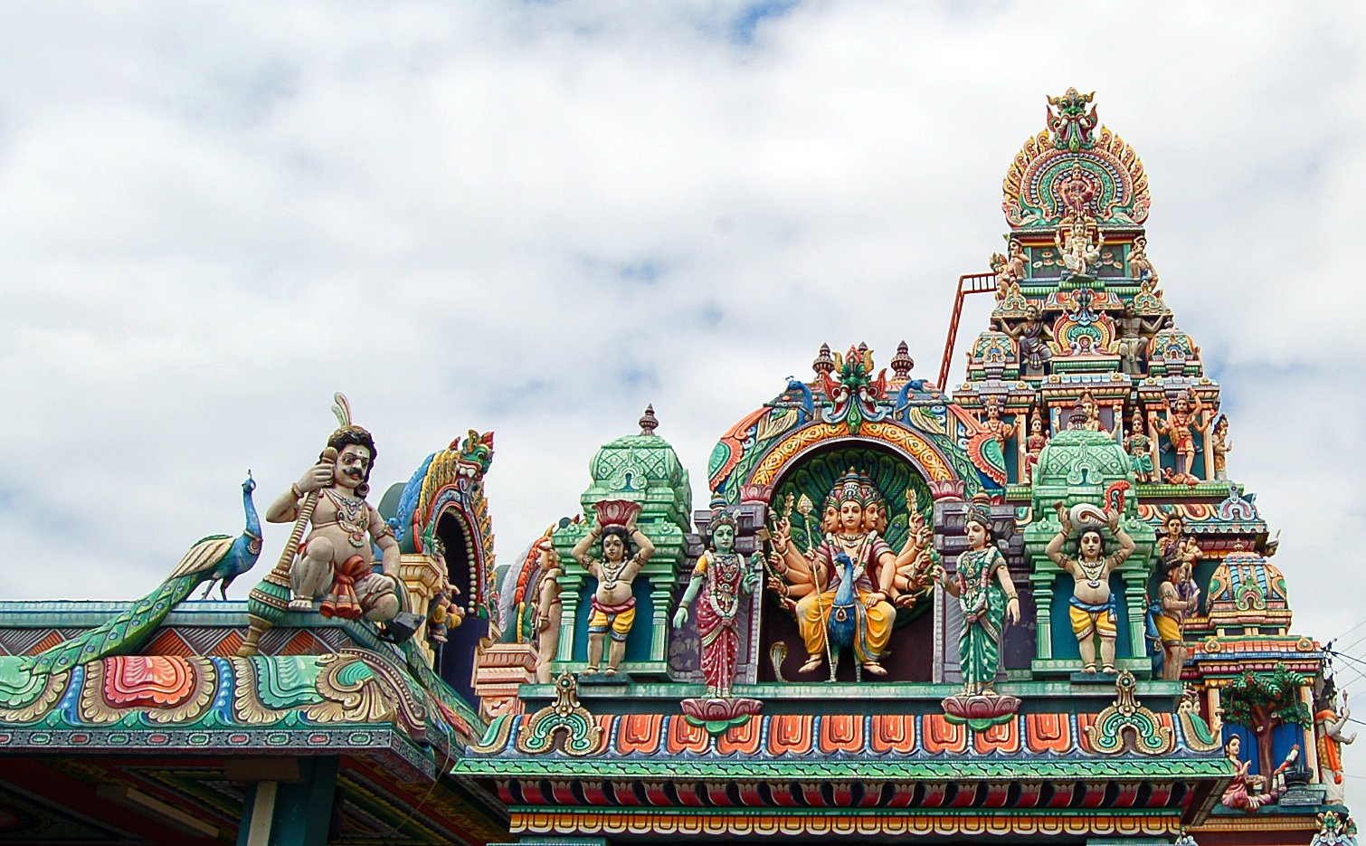 statue displayed on top of an ornate temple