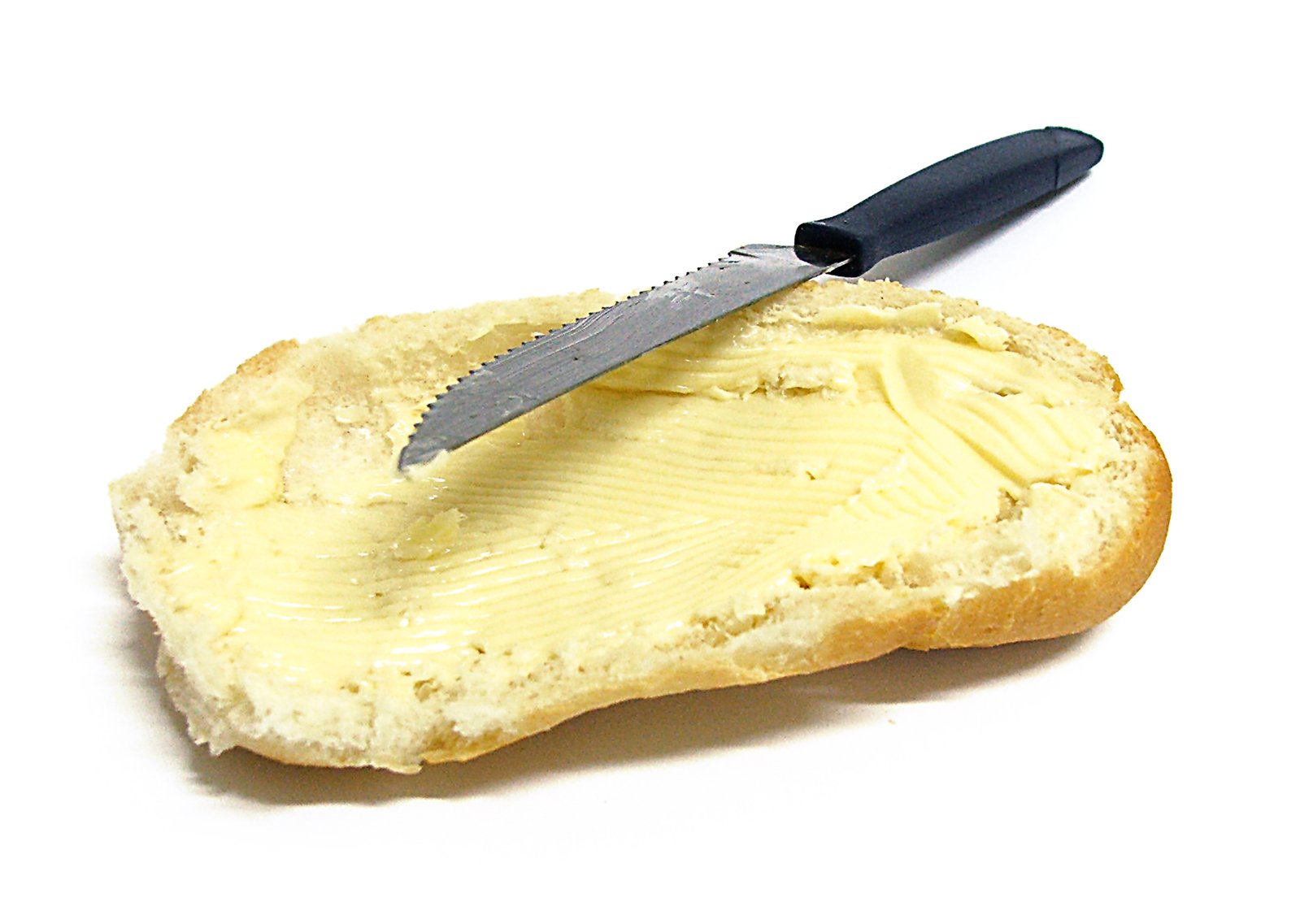 a knife sticking out of a piece of bread