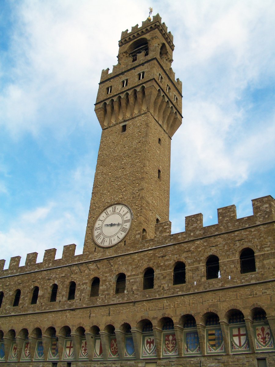 a tall clock tower in front of blue skies