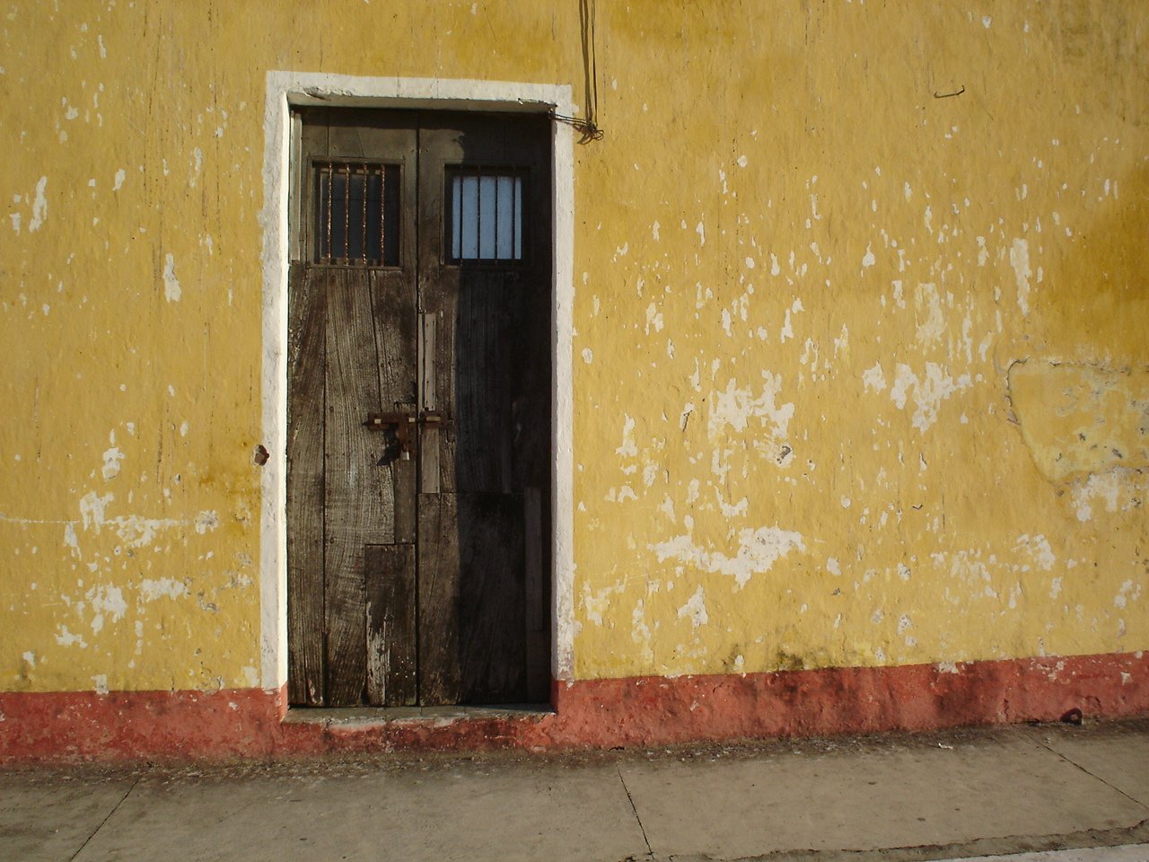 a close up of an open door to a yellow building