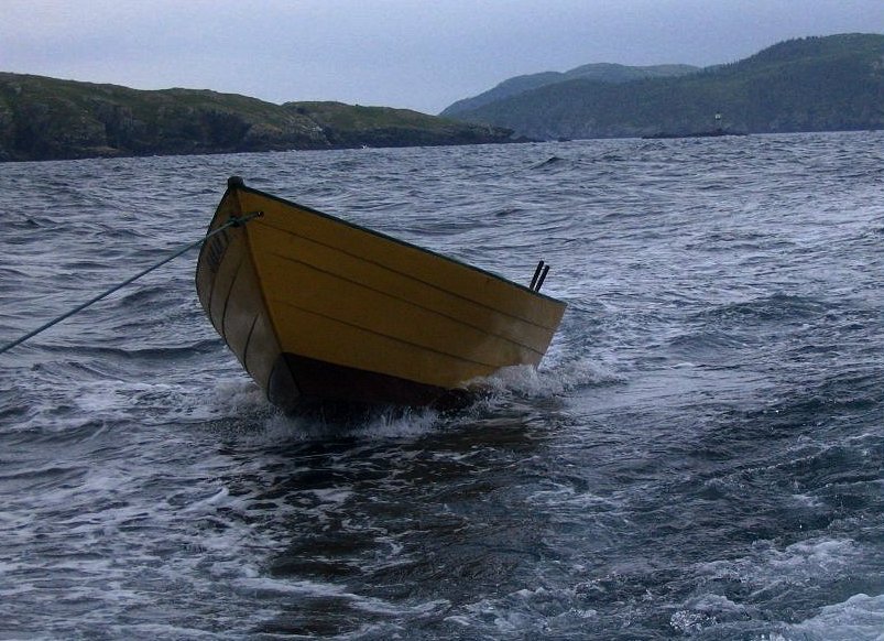 a boat is sitting on the water, near a shore