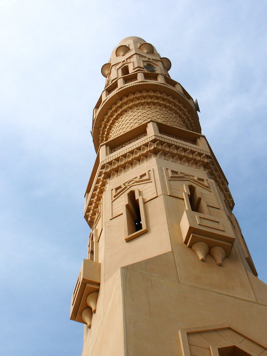 the tall bell tower is near a clear blue sky