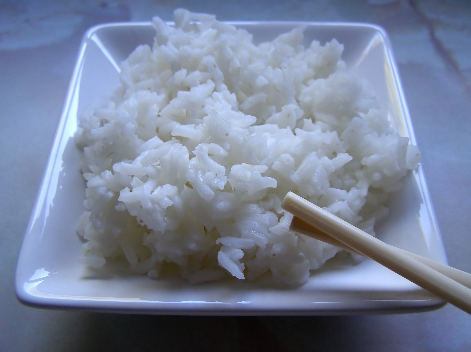 the white rice is in the dish with a fork