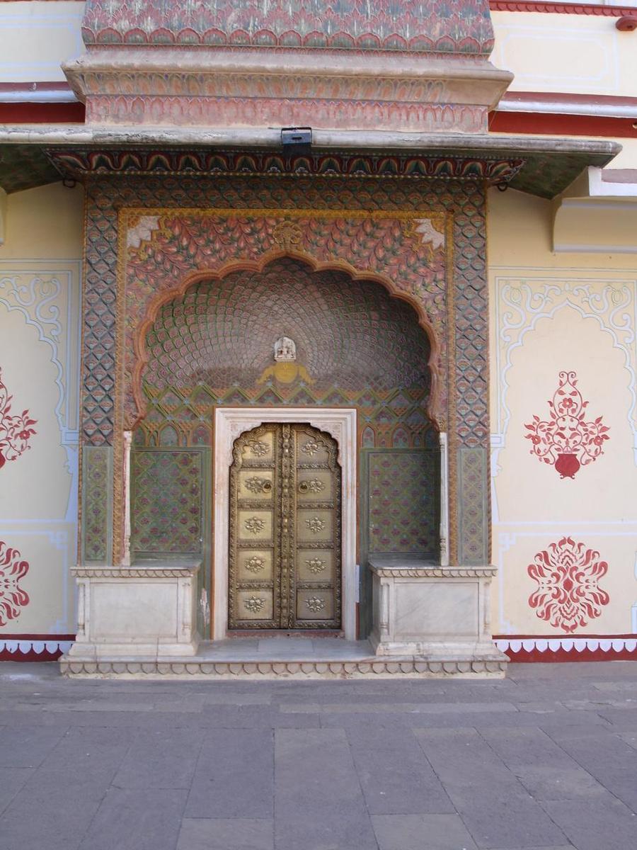 a couple of tall yellow doors sitting under an archway