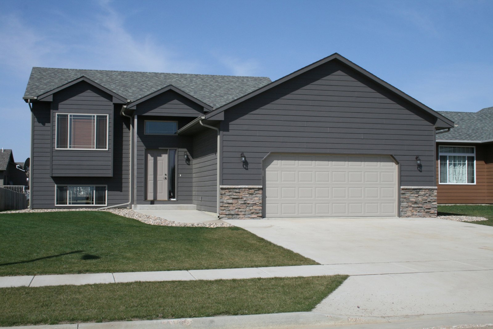 a home that has just been finished with gray exterior paint