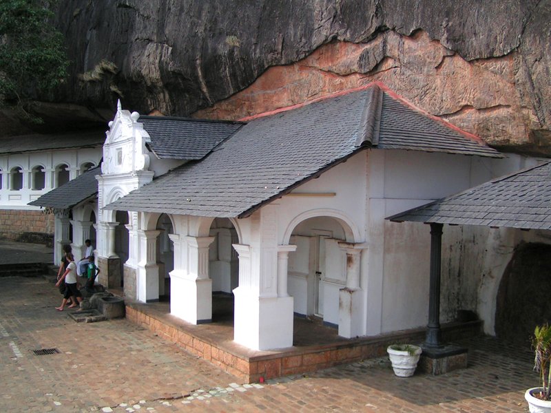 a white church built into the side of a mountain
