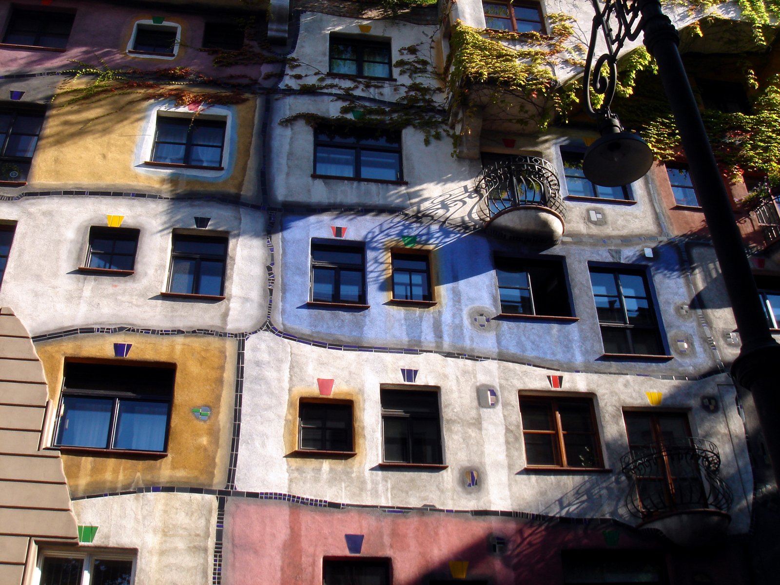 windows on a multi - colored facade of an apartment building