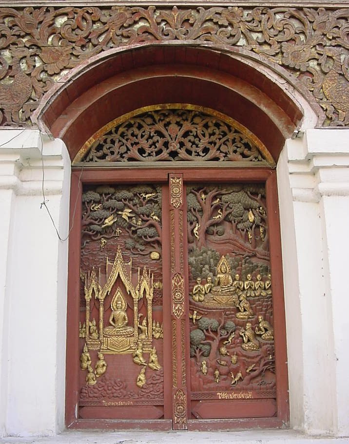 an ornate gate entrance to a building with carvings