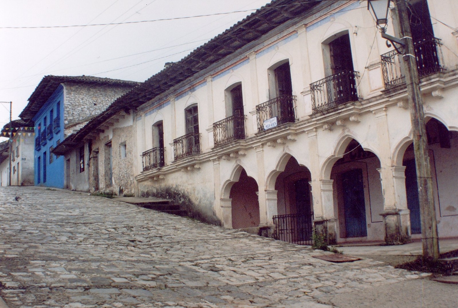 a row of old buildings on a cobblestone street