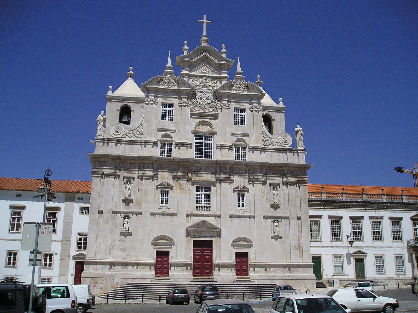 an old church with a few cars parked outside