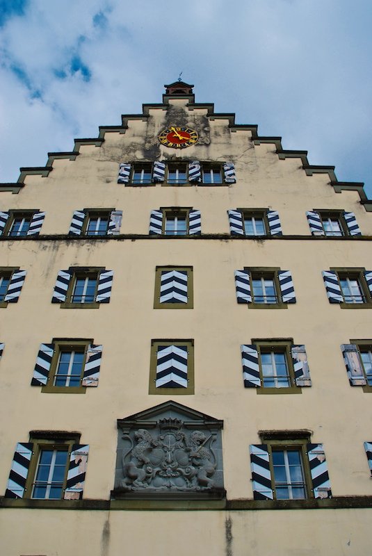 a clock on the side of a tall building