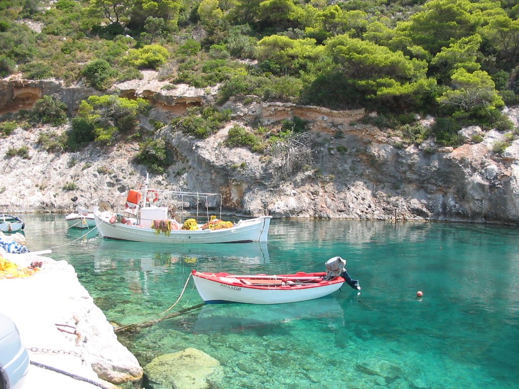 the boats are tied up near the shore