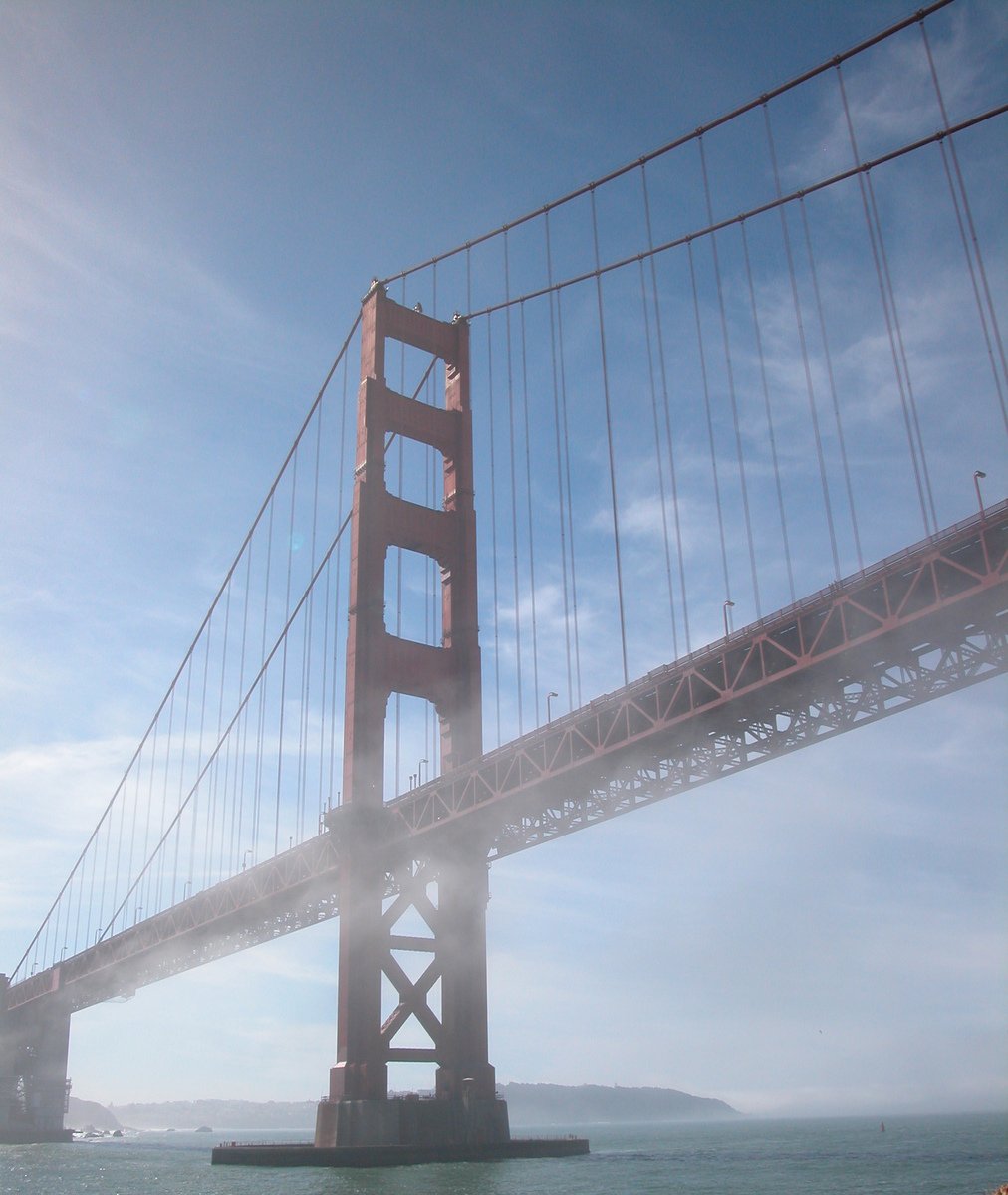 view from inside a ship of a large bridge spanning the width of the river