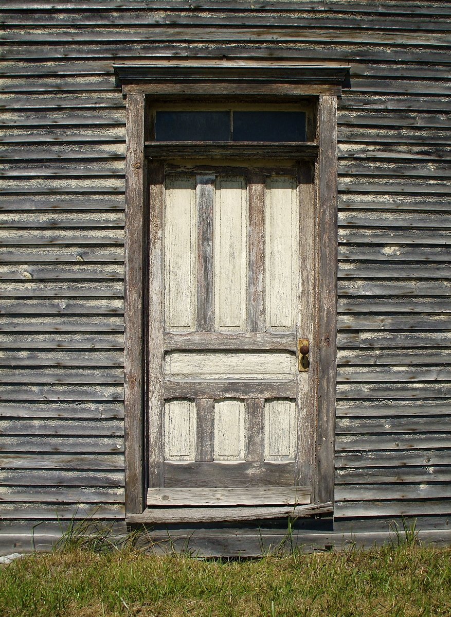 a door is shown in an old black barn