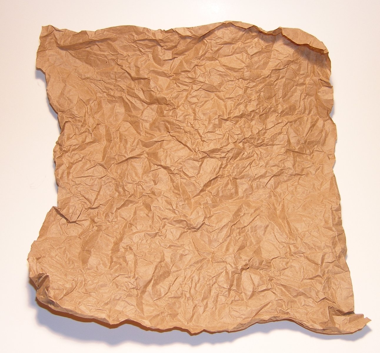 a piece of crumpled paper sitting on top of a white wall