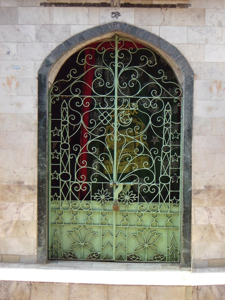 a decorative wrought iron gate surrounds a room