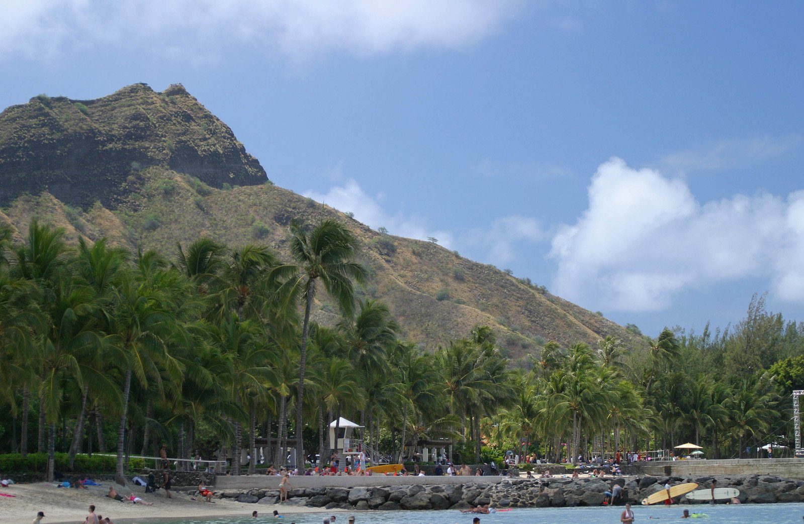 people are swimming on a tropical beach in the daytime