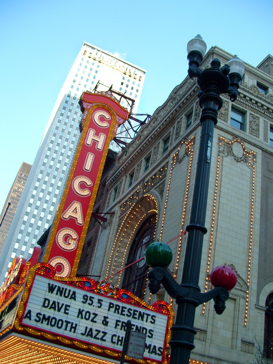 the sign for chicago theater with lights strung in it