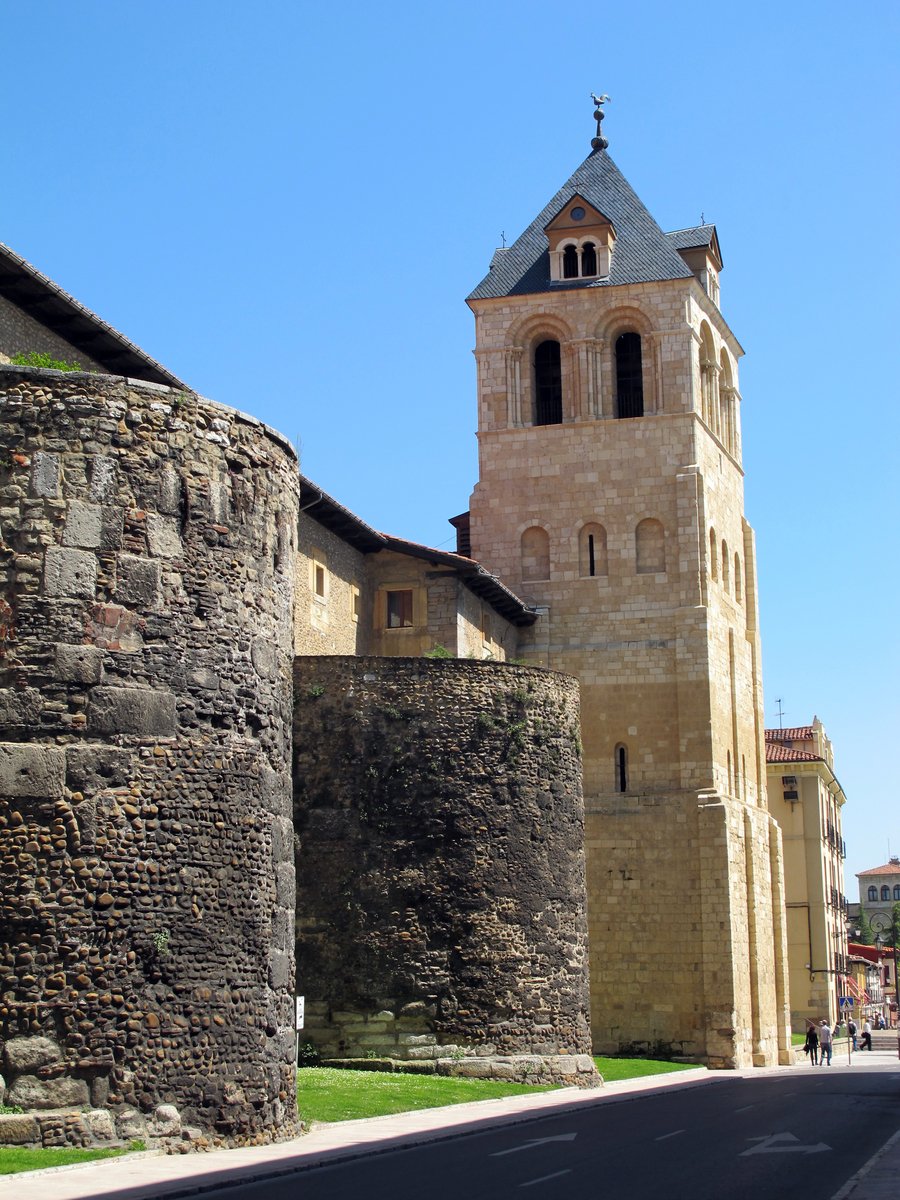 two buildings and a clock on one side of the street