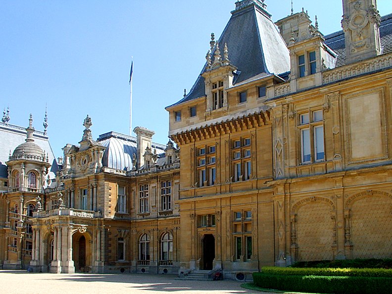 a large building with two clocks on the top of it's front