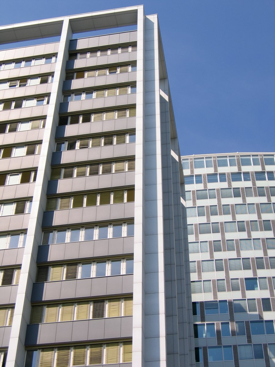 some very tall buildings with windows next to each other