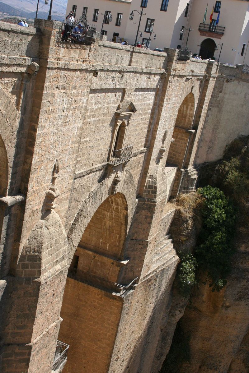 the view of an old bridge that is made of stone