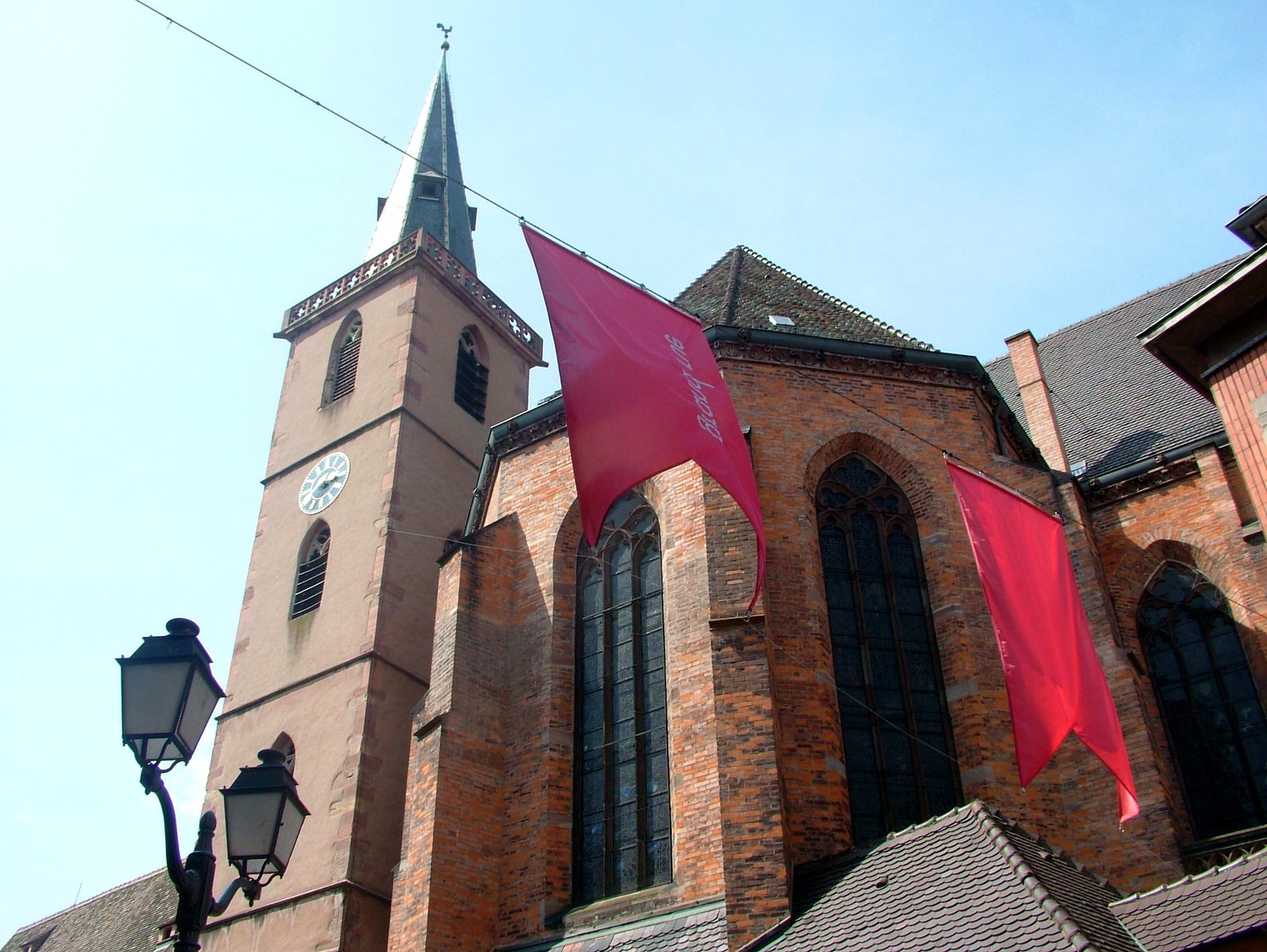 an architectural structure with red banners hanging outside