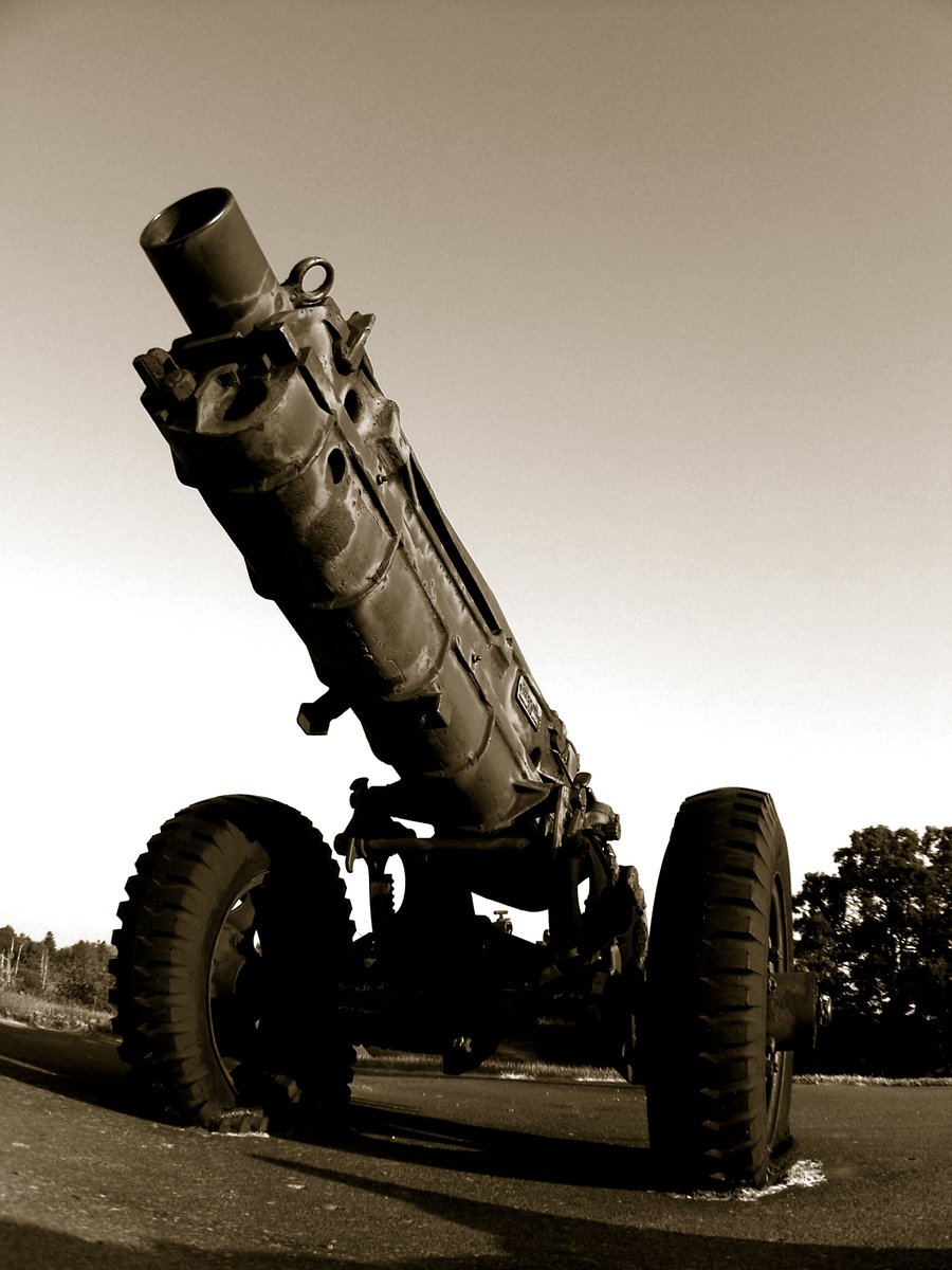 an old fashioned military vehicle sits on the ground